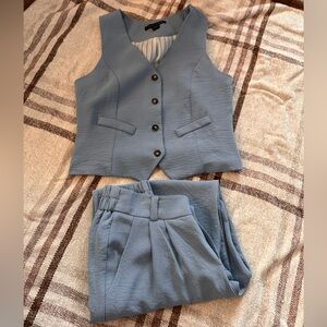 Two, two piece vest and trouser set for one